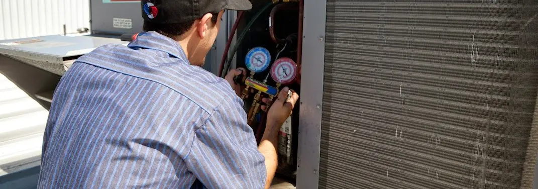 HVAC technician servicing a condenser unit in Shady Hills