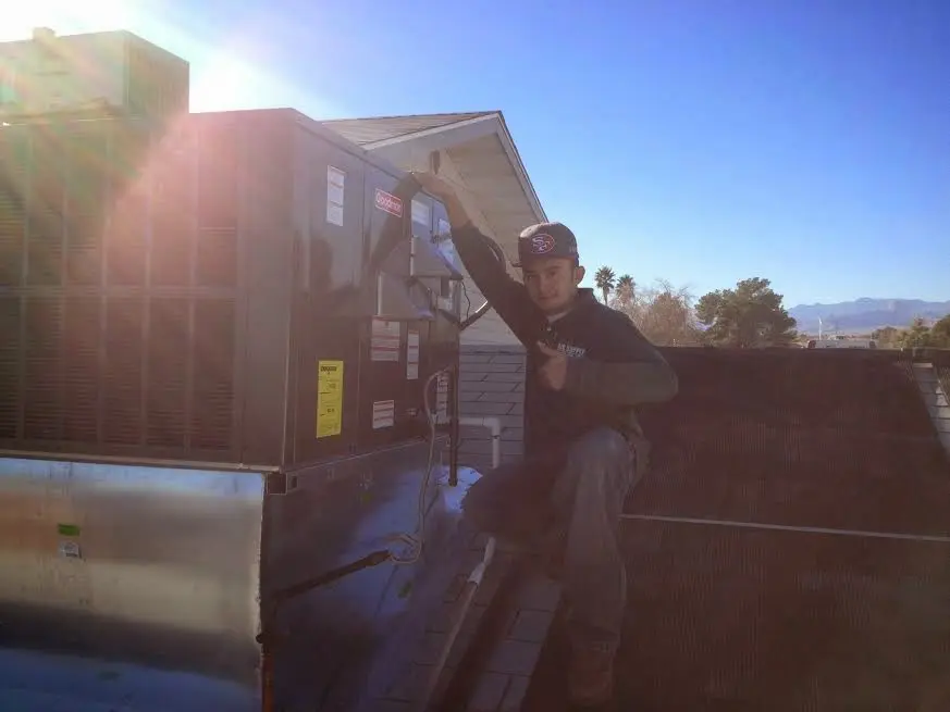 HVAC technician performing Heat Pump Repair on a rooftop unit in Shady Hills